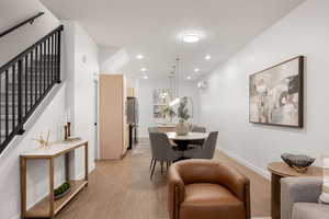 Dining space featuring light wood finished floors and recessed lighting