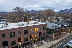 View of property with a mountain view and a residential view