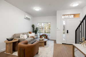 Entryway with light wood-type flooring and a textured ceiling