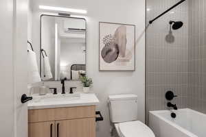 Bathroom featuring a mini split for heating / cooling, vanity, and washtub / shower combination