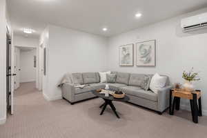 Living area with light carpet and a mini split for heating / cooling