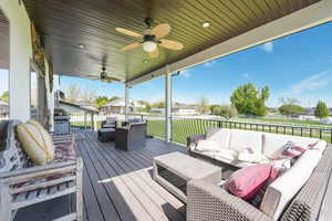 Deck featuring an outdoor hangout area, ceiling fan, a residential view, and grilling area