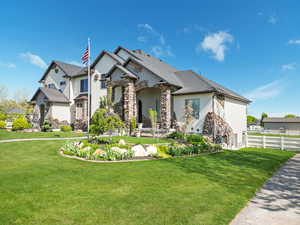 French country home featuring stucco siding and stone siding