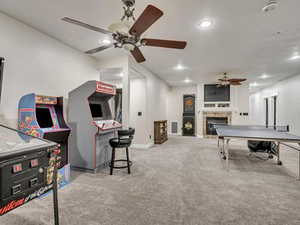 Playroom featuring a fireplace, recessed lighting, and a ceiling fan