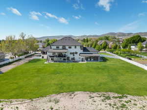 Rear view of property featuring a fenced backyard, a patio, a mountain view, and a swimming pool