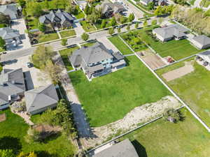 Aerial view of property and surrounding area with nearby suburban area