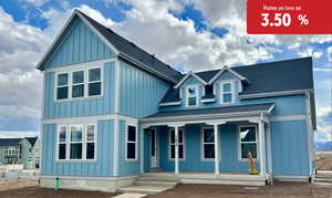 View of front facade with roof with shingles, covered porch, and board and batten siding