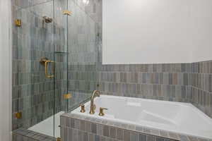 Full bathroom with a bath and a shower stall