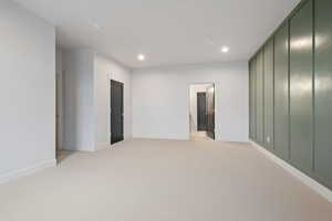 Unfurnished room featuring light carpet and recessed lighting