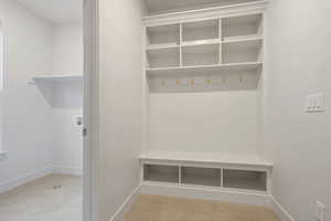 Mudroom with baseboards and light tile patterned floors