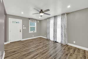 Entrance foyer with ceiling fan, wood finished floors, recessed lighting, and a textured ceiling