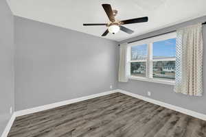 Unfurnished room with wood finished floors, ceiling fan, and a textured ceiling