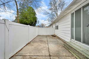 Fenced backyard with a patio