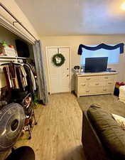 Bedroom with a closet and light wood-style floors