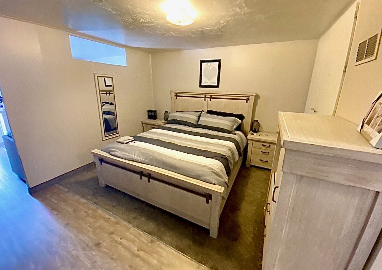 Bedroom featuring dark wood-style flooring