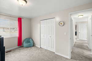 Unfurnished bedroom with carpet floors and a closet