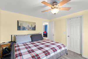 Bedroom with light carpet and ceiling fan