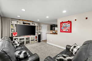 Living area featuring carpet floors and recessed lighting