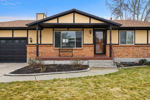 View of front of property with brick siding, a garage, concrete driveway, and a shingled roof