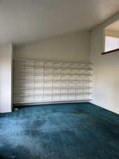 Unfurnished room featuring dark carpet and baseboards