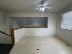 Unfurnished room with ceiling fan and tile patterned floors