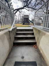 View of patio with stairway and a playground