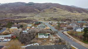Aerial overview of property's location featuring a mountainous background and nearby suburban area