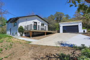 White brick exterior featuring a multi-level deck with black railing
