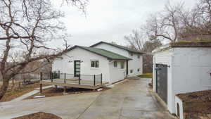 Back of house with a wooden deck and brick siding