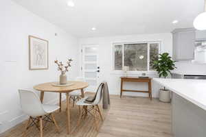 Dining space featuring light wood finished floors and recessed lighting