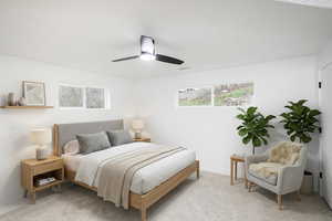 Carpeted bedroom featuring a ceiling fan