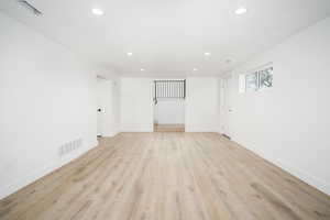 Spare room featuring light wood-style floors and recessed lighting