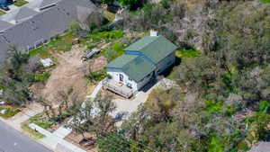 Single-story residence featuring a green shingle roof and white siding