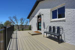 Spacious outdoor deck featuring composite decking and black metal railings