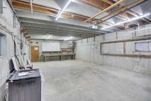 Basement with a workshop area and a heating unit
