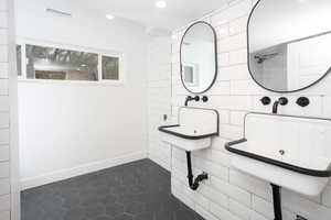 Bathroom featuring dark tile patterned floors and recessed lighting