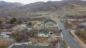 Aerial view of property's location with mountains and nearby suburban area