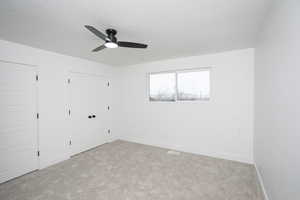 Spare room featuring carpet, a textured ceiling, and ceiling fan