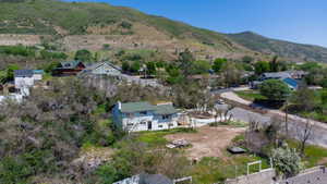 Two-story residence with a green roof situated on a sloped lot