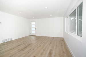 Unfurnished room with light wood finished floors and recessed lighting