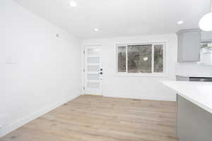 Unfurnished dining area featuring light wood-style floors and recessed lighting