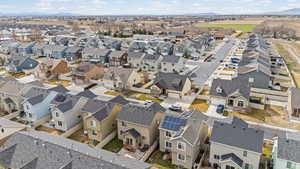 Aerial overview of property's location with a mountain backdrop and nearby suburban area