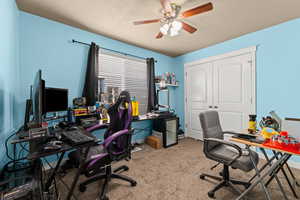 Carpeted home office with ceiling fan