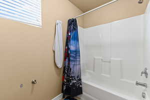Bathroom featuring shower / bath combination with curtain