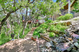 View of home's community featuring a deck and stairs