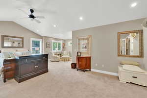 Bedroom featuring light colored carpet, vaulted ceiling, recessed lighting, and ceiling fan