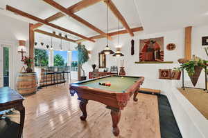 Playroom with billiards table, hardwood / wood-style floors, and beamed ceiling