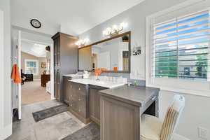 Full bathroom featuring vanity, vaulted ceiling, backsplash, and light colored carpet