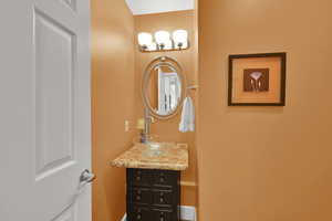 Bathroom with vanity and baseboards