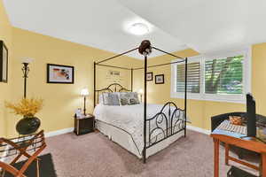 Carpeted bedroom featuring baseboards